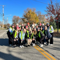 Group of volunteers from Alpha Sigma Alpha pose for photo during 5K